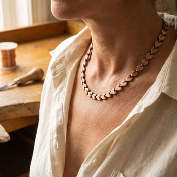 Copper chain necklace worn with linen shirt